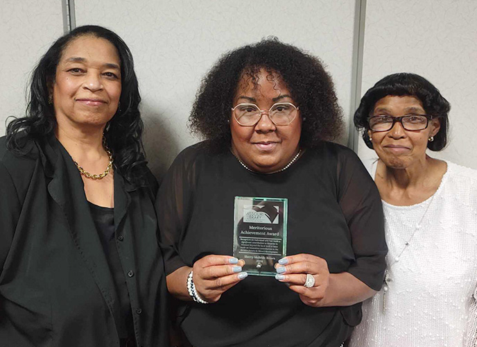 Sherry's relatives receiving her award in her honor