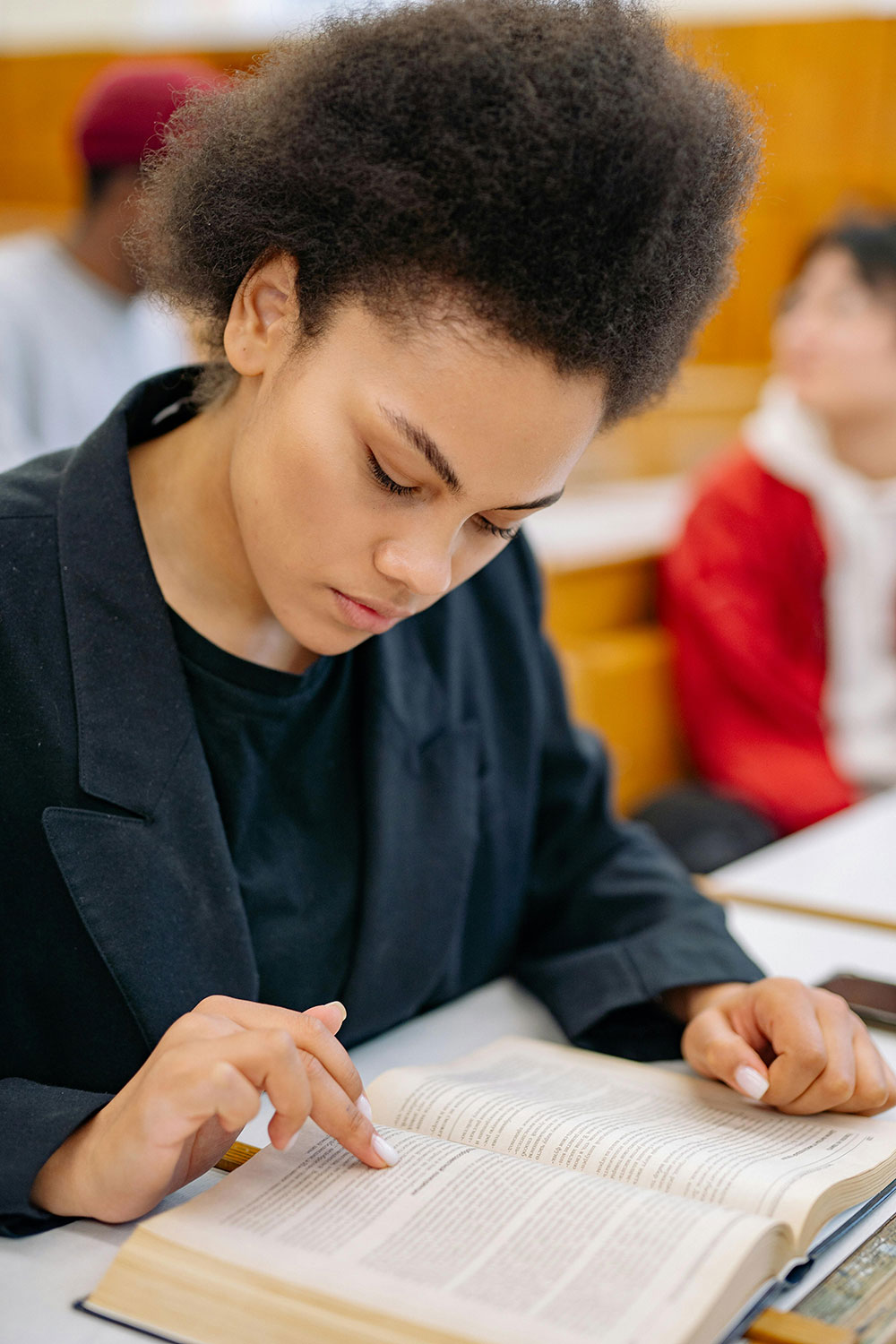 Young woman focused on reading a book