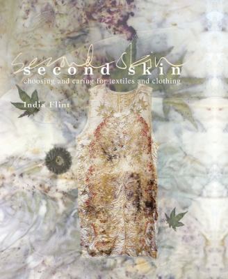 Second Skin book cover: A grungy background with a white, wrinkled over-printed dress in focus. Title is in white.